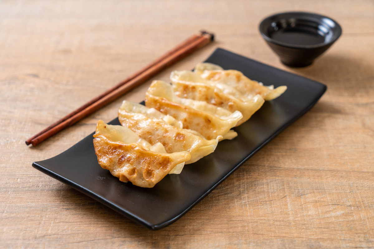 Fried Japanese gyoza dumplings with soy sauce
