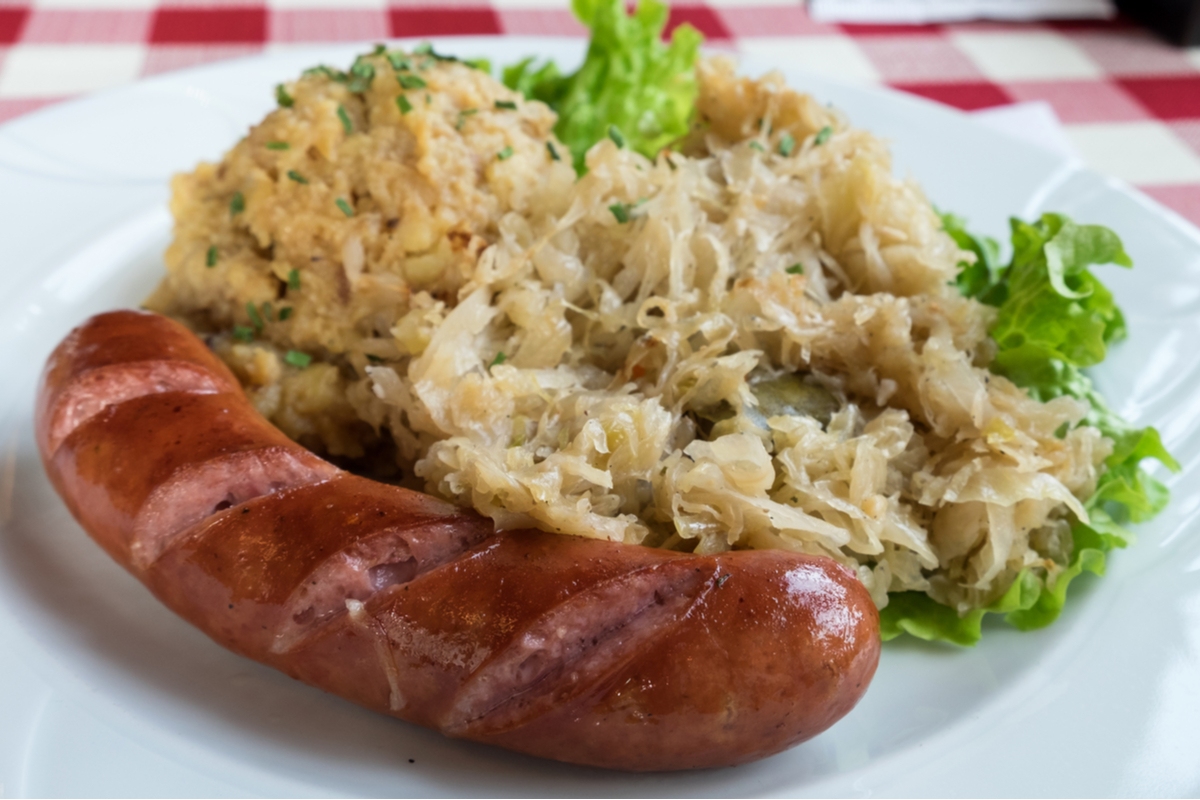 Plate of local food from Slovenia. Tradiitonal sausage and horseradish.