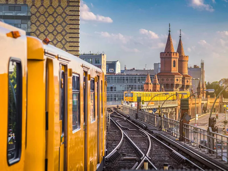 Panoramic view of Berliner U-Bahn with Oberbaum Bridge in the background in golden evening light at sunset with retro vintag
