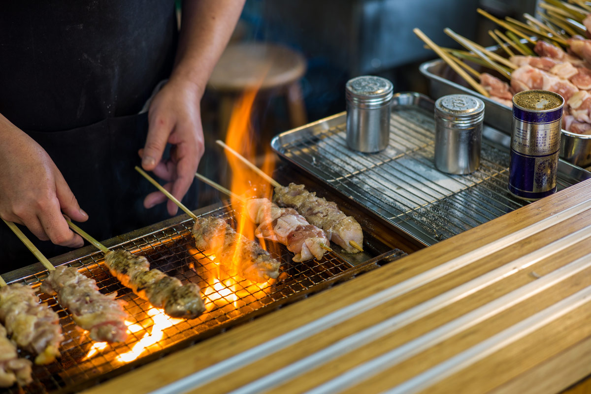 Traditional yakitori chicken stand in Japan at street food vendor market